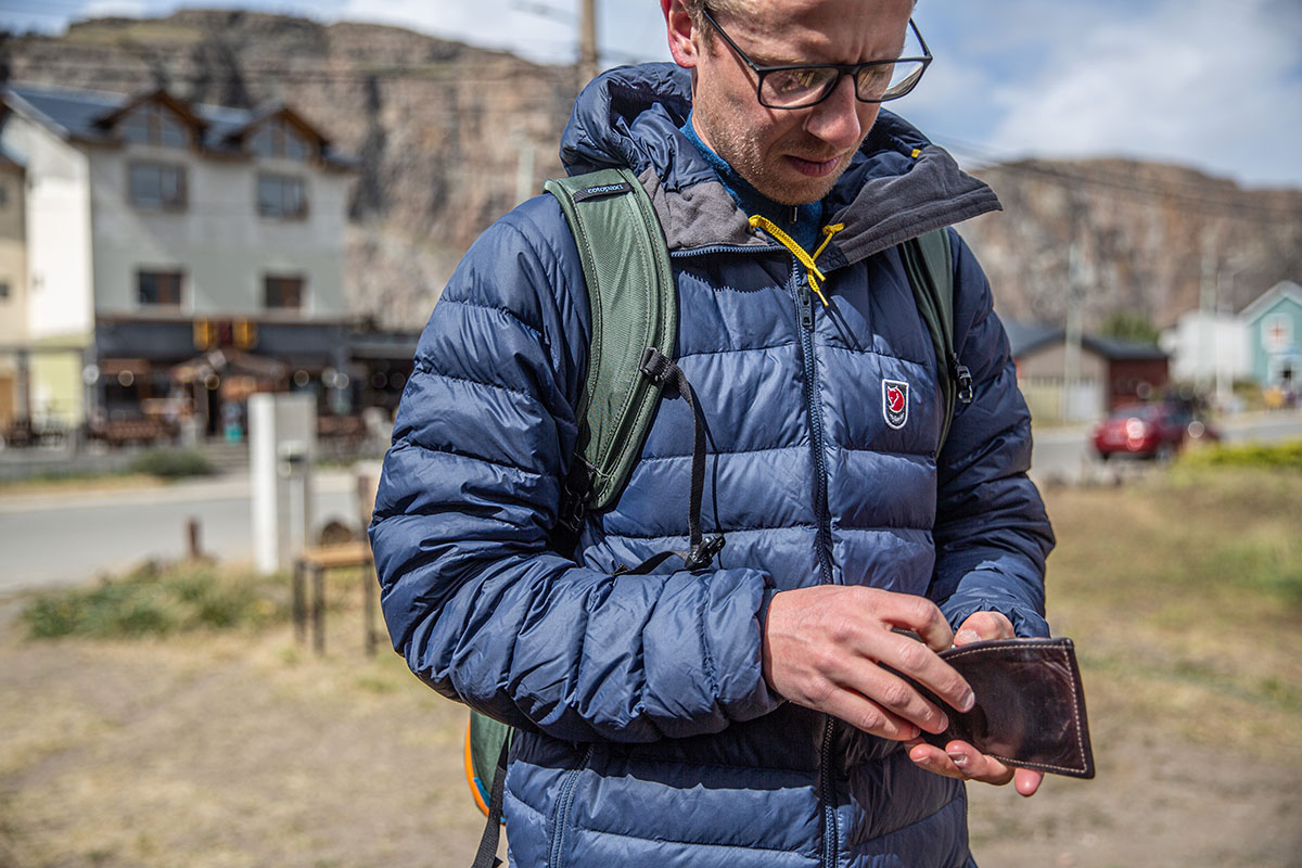 Fjallraven Expedition Pack Down Hoodie (opening wallet in town on a sunny day)